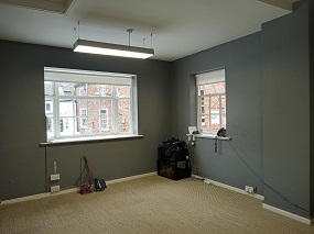 The office space for the property 2 Newgate, 2 windows, carpeted floor and overhead light