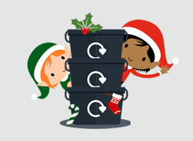 a comic drawing of 3 black recycling boxes, each with a recycle logo, stood atop each other, with two elves, one in red and one in green waving from behind the boxes.