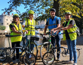 A photo of cycle trainers stood in bright clothing overlooking Lendal Bridge and the River Ouse