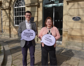 Peter Roderick, Director of Public Health and Cllr Lucy Steels Walshaw, Executive Member for Health, Wellbeing and Adult Social Care, hold signs supporting the Yes to Quit campaign outside West Offices