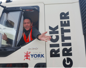 Rick Witter sits in the cab of a gritting vehicle with the name Rick Gritter on the side of the cab