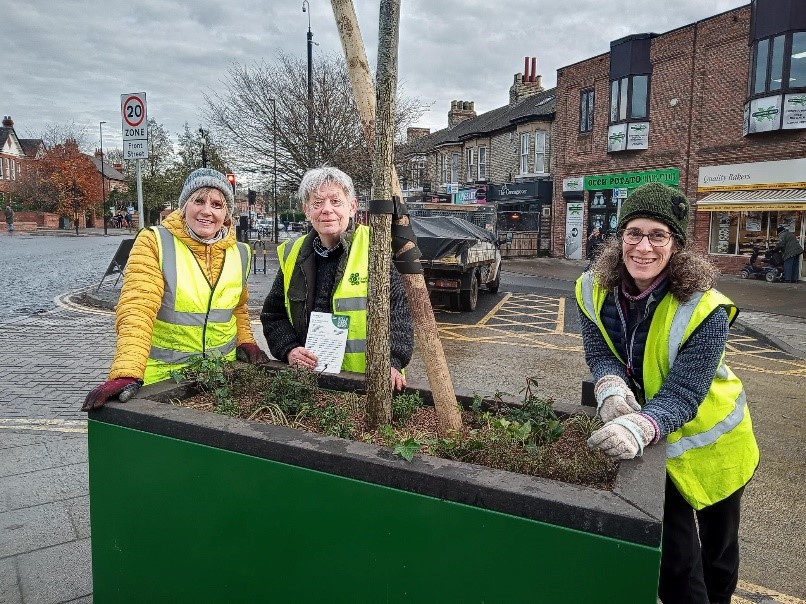 Volunteers from Greater Acomb community Forum planting the new containers on Front Street