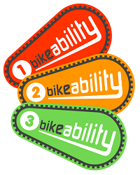 Bikeability logo, with red, amber and green elliptical shapes, each having a black bike chain border and numbered 1, 2 and 3 to reference levels of cycle training.