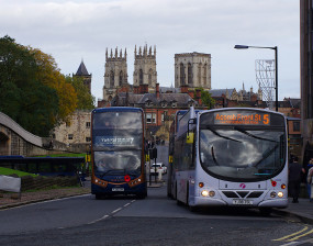 EV and diesel bus, Minster in background