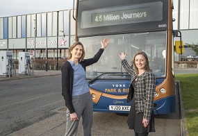 Councillor Kate Ravilious, Executive Member for transport at CYC, stands with Kayleigh Ingham, Commercial Director of First Bus North and West Yorkshire in front of a double decker bus to celebrate four and a half million passengers