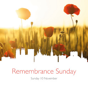 A wheatfield studded with poppies and the text Remembrance Sunday