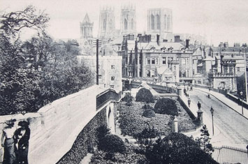 Old black and white postcard showing York Minster from the City Walls