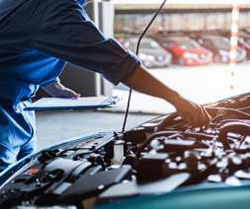 Close up of mechanic's hands, working on a car engine.