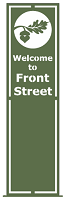 A green banner flag that reads Welcome to Front Street with an oak leaf logo