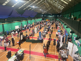 York jobs fair held in a sports centre with lots of stalls with people visiting each stall